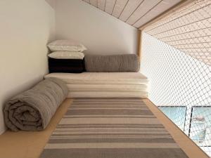 a bed in a room with blankets and a window at Modern And Stylish Summer Cabin in Vejby