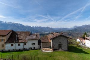 a group of buildings in a field with mountains in the background at Casa di Angelina in Avaglio