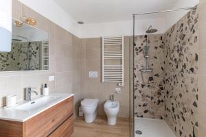 a bathroom with a sink and a toilet and a shower at Casa di Angelina in Avaglio
