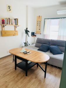a living room with a couch and a coffee table at 易居の宿 in Osaka