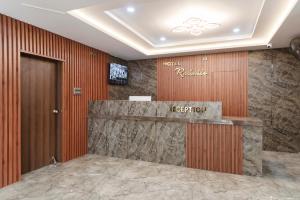a lobby of a hotel with a reception desk at Hotel Rasballa Grand in Bhadrāchalam Road