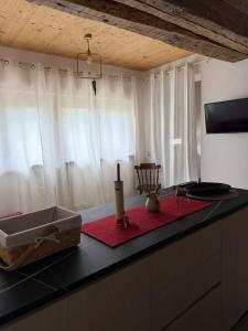 a kitchen counter with a sink and a candle on it at Cozy tiny flat in Cadore Dolomiti in Calalzo +4 photos