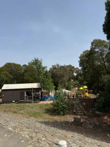 a park with a building and a playground at Vino Domus in Cabeção