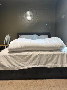 a bed with a white comforter in a bedroom at Plattsburgh Stay in Plattsburgh