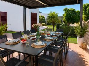 a black table with chairs and food on a patio at Lux Villa with Year-Round Heated Pool & Game Room in Montequinto