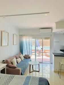 a living room with a couch and a table at Hotel PYR, Spacious Studio with a Big Terrace in Fuengirola +23 photos