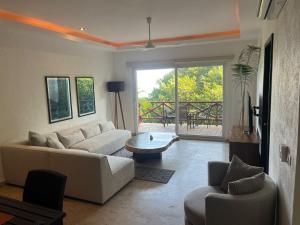 a living room with a couch and a table at Condo Solana Oceanview and Jungle Bliss! in Sayulita