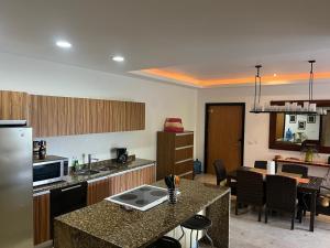 a kitchen with a counter top and a dining room at Condo Solana Oceanview and Jungle Bliss! in Sayulita