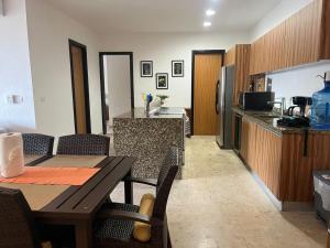 a kitchen and dining room with a table and a counter at Condo Solana Oceanview and Jungle Bliss! in Sayulita