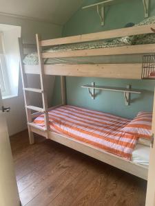 a bedroom with two bunk beds with a ladder at Oude Dorp Zicht in Urk