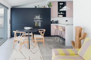 a kitchen with a dining room table and chairs at Casa Alegra in Carvalhal