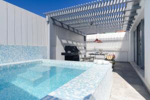 a swimming pool with a blue and white tile floor at Casa Alegra in Carvalhal