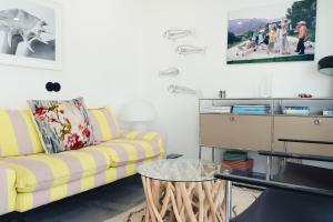 a living room with a yellow couch and a glass table at Casa Alegra in Carvalhal