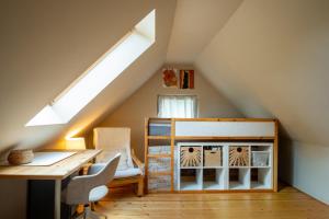 a room with a desk and a bed in a attic at Kouzelný domeček in Ostrava