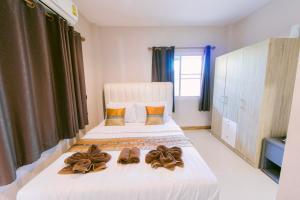a bedroom with a bed with shoes on it at Amphawan in Ban Nong Khrai Luang