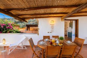 a dining room with a table and chairs at Sea View Within Walking Distance of the Beach in Baja Sardinia +12 photos