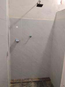 a shower stall with a glass door in a bathroom at Hostal La Cabaña in Mesetas