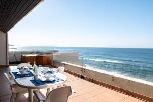 a table on a balcony with a view of the ocean at Chaka Terraces 10 in Ballito