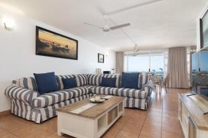a living room with two couches and a table at Chakas Cove 34 in Ballito