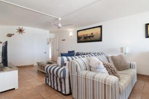 a living room with two couches and a tv at Chakas Cove 34 in Ballito +17 photos