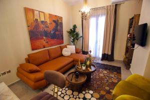 a living room with a couch and a table at Chrysiida Luxury Apt, Stroll to Nafplio Center in Nafplio