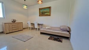 a living room with a dog bed and a table at Bos-Znam Pokoje in Gdynia