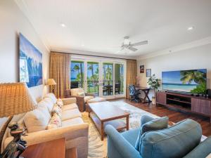 a living room with a couch and a tv at 3-Bed Villa 203 at Turtle Bay in Kahuku