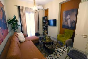 a living room with a couch and a green chair at Chrysiida Luxury Apt, Stroll to Nafplio Center in Nafplio