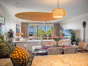 a dining room and living room with a table with fruit at 3-Bed Villa 203 at Turtle Bay in Kahuku