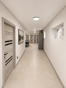 an empty hallway with a door and a table at EVURI Rooms in Uzhhorod