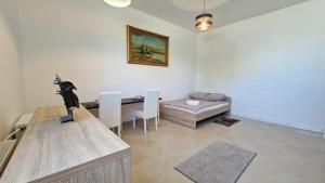 a living room with a table and a couch at Bos-Znam Pokoje in Gdynia