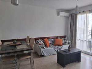 a living room with a couch and a table at DEPTO 2 Y 62 CON COCHERA PROPIA in La Plata