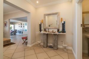 a hallway with a mirror and a sink in a home at Colwyn Drive 53 in Sheffield Beach +27 photos