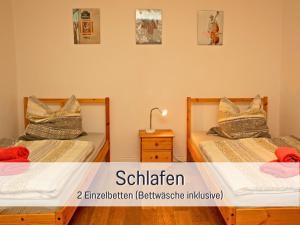 two beds sitting next to each other in a room at Hof Heideland 1 in Eichholz