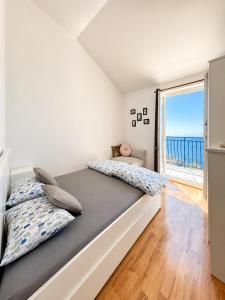 a bedroom with a bed with a view of the ocean at Apartment Iris in Dubrovnik