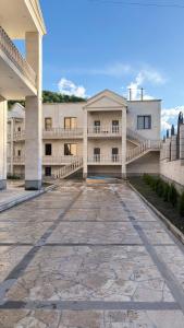 an empty courtyard of a building with a balcony at Harutyunyants Hall in Ijevan +26 photos