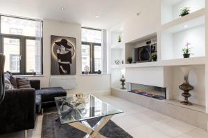 a living room with a couch and a fireplace at Bradford Chic City-Centre Apartment in Bradford +11 photos