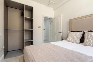 a bedroom with a large bed and a closet at Bradford Chic City-Centre Apartment in Bradford