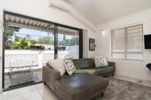 a living room with a couch and a large window at La Mer 14 in Ballito