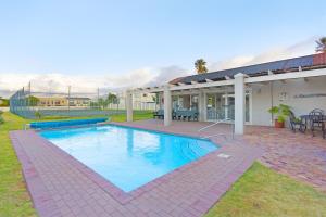 a swimming pool in the yard of a house at Sea Haven 4 in Gordonʼs Bay