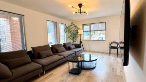 a living room with a couch and a table at Ts House Hakodate Park Front in Hakodate