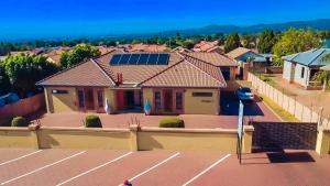 a house with solar panels on the roof at Divine Guest Lodge in Rustenburg