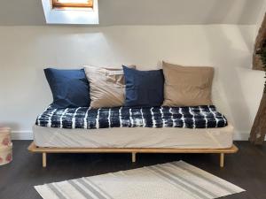 a bench with pillows on it in a room at La Vieille Demeure in Barbizon