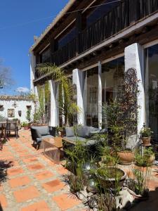 a patio with furniture and plants on a building at La Guzmana de Ronda in Ronda