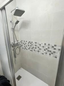 a bathroom with a shower with a checkerboard tile at Casa Arrabal Villa in Salobreña