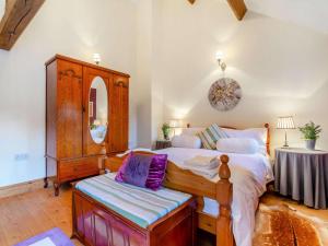 a bedroom with a bed and a dresser and a table at 3 Bed in Appleby-in-westmorland oc-88791 in Crackenthorpe