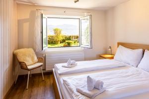 a bedroom with two beds and a window at Luna in Thun