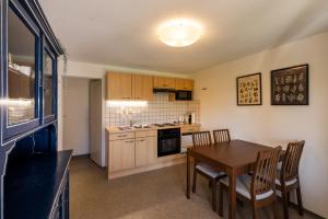 a kitchen and dining room with a table and chairs at Luna in Thun