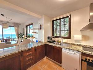 a kitchen with a counter top with a view of the ocean at Sea View Chalet - Altea Hills in Altea