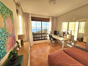 an office with a desk and a computer in a room at Sea View Chalet - Altea Hills in Altea